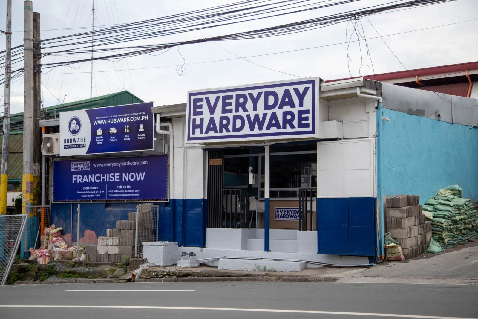 Muntinlupa Branch storefront with Everyday Hardware signage and building supplies beside the entrance